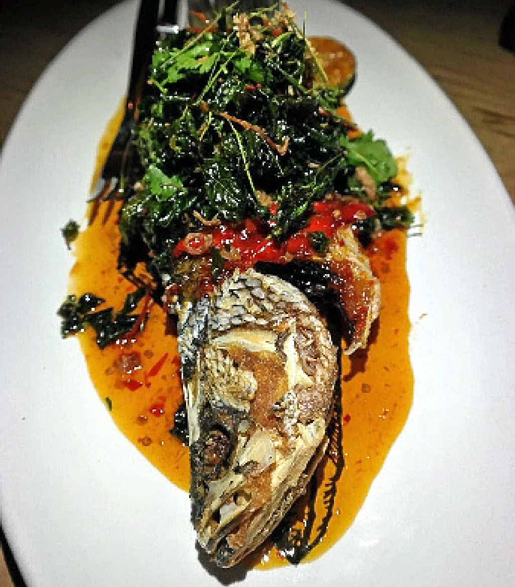 One of Hujan Locale’s delicacies – crispy fish served with sweet chilli sauce, coriander lime leaf and deep fried basil. One of Hujan Locale’s delicacies – crispy fish served with sweet chilli sauce, coriander lime leaf and deep fried basil.